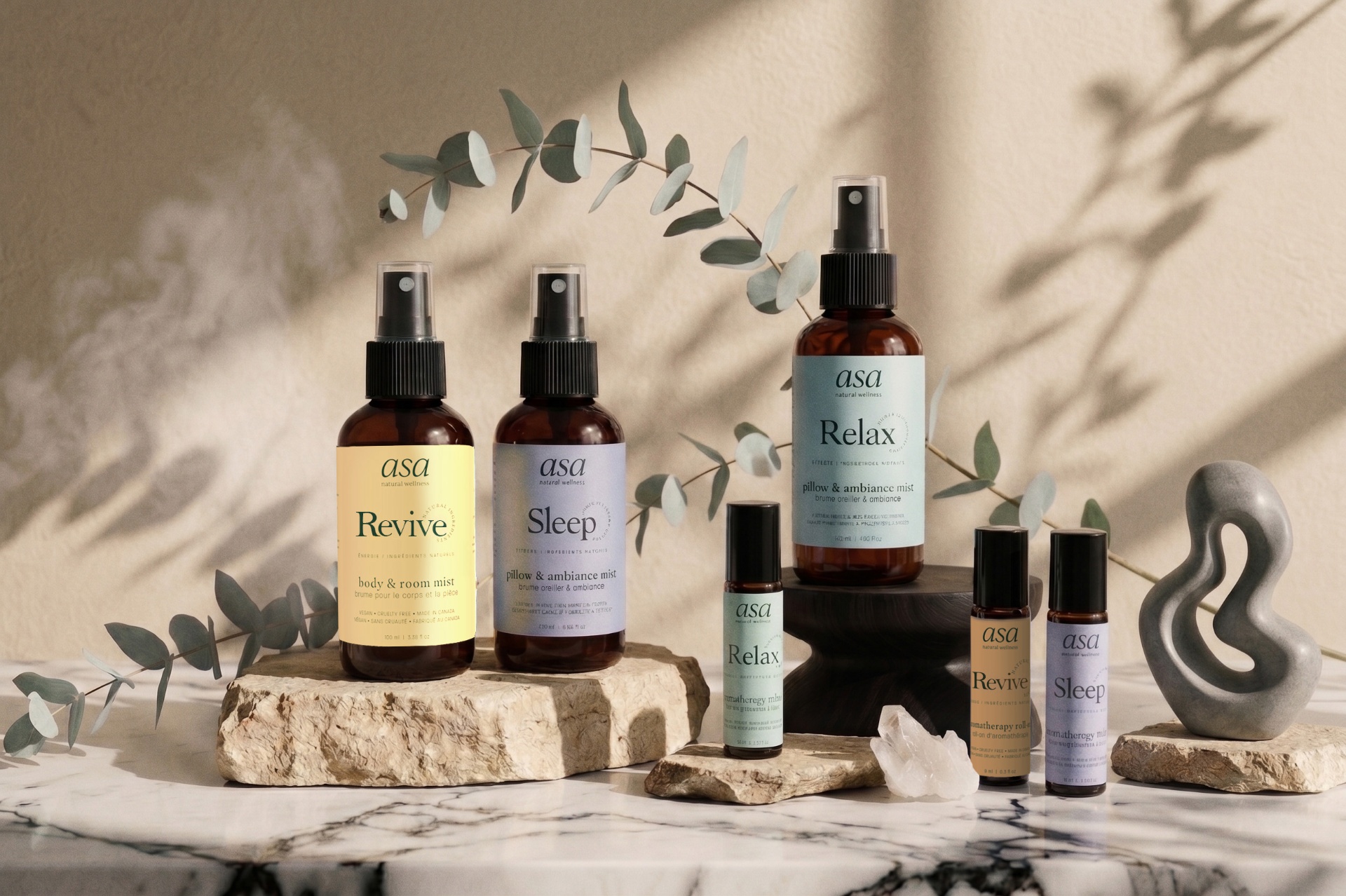 ASA Sleep, Revive and Relax mists and roll-ons on marble with eucalyptus branches