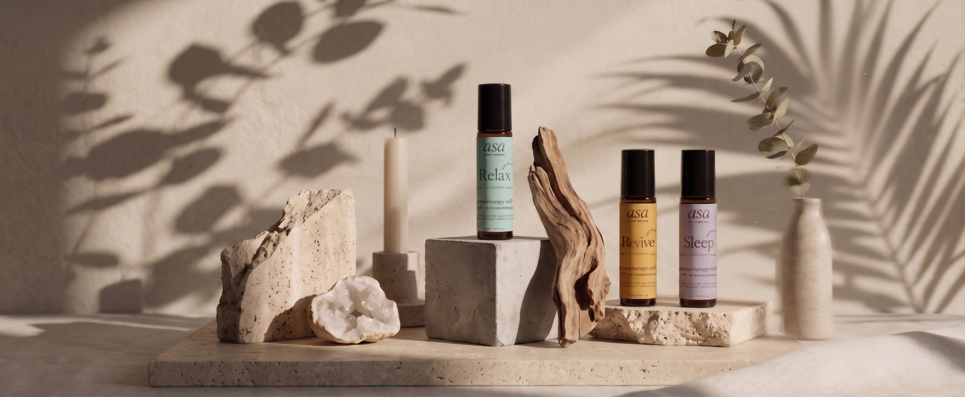 ASA Sleep, Revive and Relax aromatherapy roll-ons on driftwood with stones