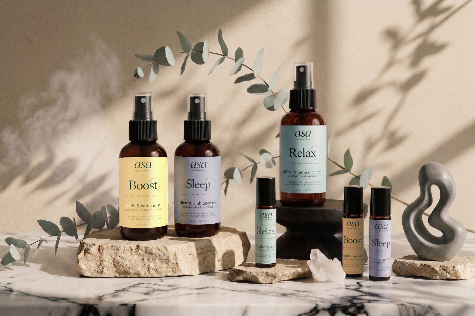 ASA Sleep, Boost and Relax aromatherapy collections arranged with crystals on marble